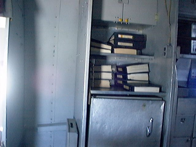 in the cabin facing to starbord looking at log books